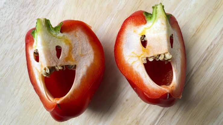 Two halved bell peppers that resemble laughing faces